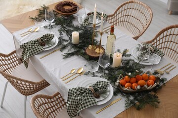 Christmas table setting with festive decor and dishware indoors