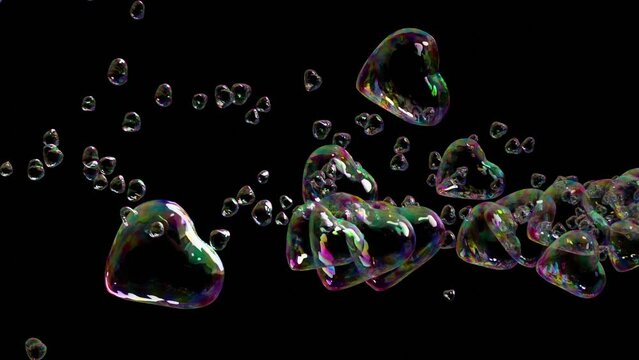 Video transition effect of romantic colorful heart shaped soap bubbles to be used as an overlay to the footage. Good  for wedding or valentine video. Isolated to black. 3d rendering