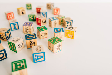 Group of Wooden Alphabet Blocks on Table - obrazy, fototapety, plakaty