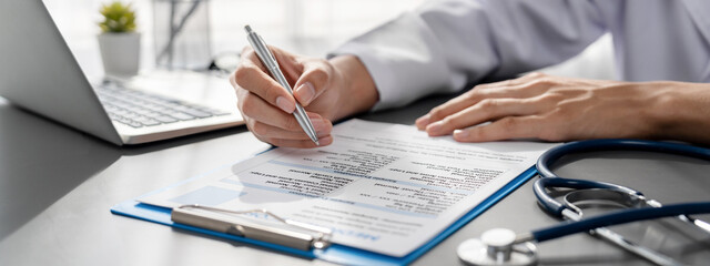 Doctor carefully review detailed medical report with laptop and diagnosing illness for effective...