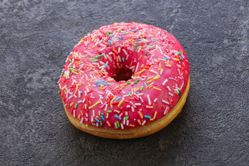 Sweet glazed struwberry donut with icing