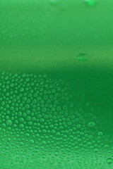 water drop on green beverage cans background, texture of cold aluminium drink package