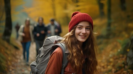 a happy teenage girl walking along a mountain path colored with autumn leaves with friends. A beautiful forest landscape. generative AI