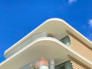 Summer white house on the beach with blue sky. Close-up of part of a house structure. Villa...