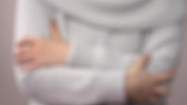 Defocus, closeup shot of a young woman scratching her arms. 4K  Blurred shot of the itchy body with skin problem.