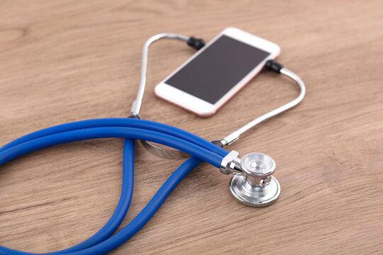 Mobile phone hanging on stethoscope for online consultation