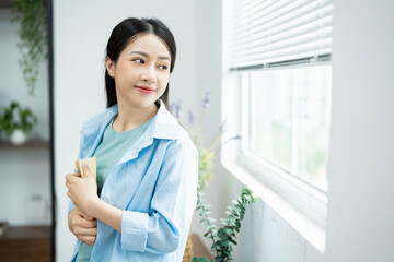 Photo of young Asian woman at home