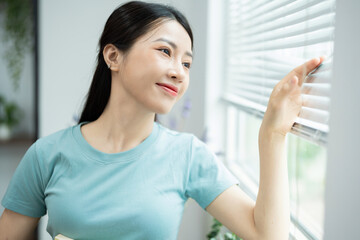 Photo of young Asian woman at home