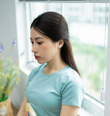 Photo of young Asian woman at home