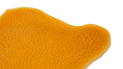 Isolted spilled cola with small bubbles on white background.