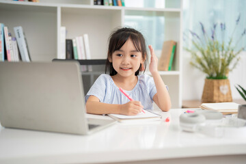 Photo of young Asian baby girl studying at home