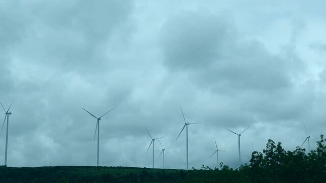 Windmill wind energy farm work well on cloudy sky sustainable alternative green enery solution 4k