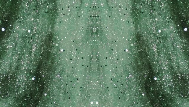 Abstract background. Shimmering flow. Glitter rain. Silver shiny round particles falling down in green liquid paint mysterious symmetrical art.