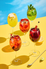 A collection of vibrant summer cocktails against a blue sky, perfect for a sunny day's refreshment