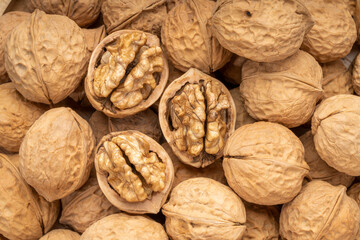 Walnuts in wooden tral on wooden background, Walnuts kernels on wooden table.