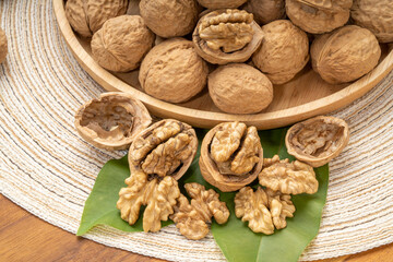 Walnuts in wooden tral on wooden background, Walnuts kernels on wooden table.