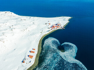 An Antarctic base on a snowy field with heart-shaped drift ice on a cold winter day