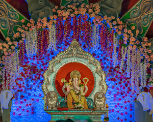 Closeup , landscape view of decorated and garlanded Isolated idol Hindu God Ganesha in Pune ,Maharashtra, India.