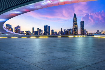 Empty square floor and bridge buildings with city skyline at dusk in Shenzhen, Guangdong Province, China.