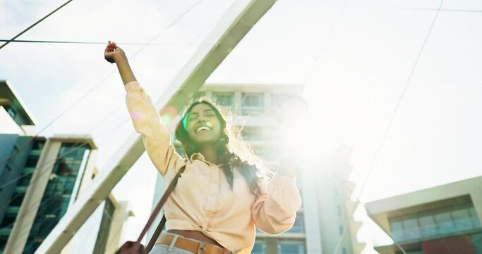 Business woman, dancing in city with coffee and enjoyment, energy and happy for commute, travel and radio. Indian girl, lens flare and sunlight with audio, sound or bag outdoor for relax and smile