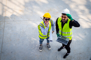 Engineer inspect building structure technicians looking at analyzing unfinished construction project