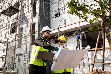 Fototapeta premium Engineer inspect building structure technicians looking at analyzing unfinished construction project