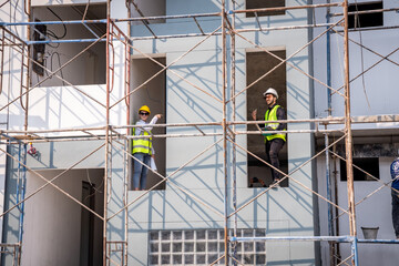 Fototapeta premium Engineer inspect building structure technicians looking at analyzing unfinished construction project