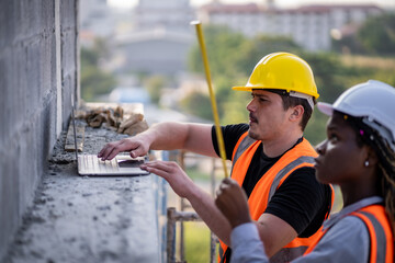 Fototapeta premium Engineer inspect building structure technicians looking at analyzing unfinished construction project