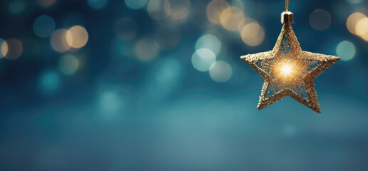 A solitary glittering gold star ornament hangs against a dreamy blue background with soft golden bokeh, radiating festive warmth and holiday magic.