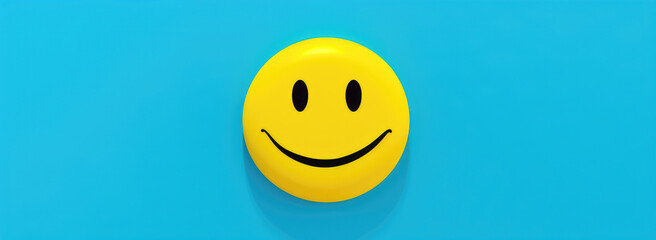 Fototapeta premium A classic yellow smiley face emoticon on a cheerful sky blue background.