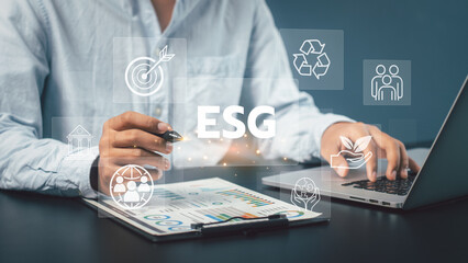 
Businessman touched ESGicons .close to the computer screen in business investment strategy concept,ESG environment social governance investment business concept. 