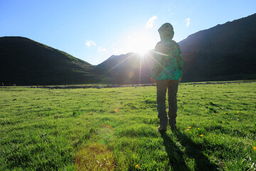 Woman enjoy the view on high altitude grassland