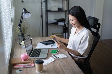 Woman on desk with smartphone, credit card and ecommerce payment for online shopping at home. Happy female customer, digital bank app and sale on store website with internet banking