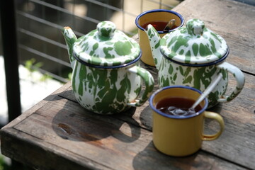 Teh Poci Gula Batu, Teko Blirik. is hot tea sweetened with rock sugar, served with an antique...
