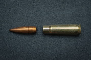 Disassembled 7.62x39mm caliber cartridge.  Bullet and cartridge case from a rifle. - obrazy, fototapety, plakaty