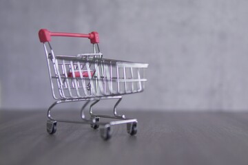 Closeup image of red shopping trolley with copy space for text. Business and shopping concept.