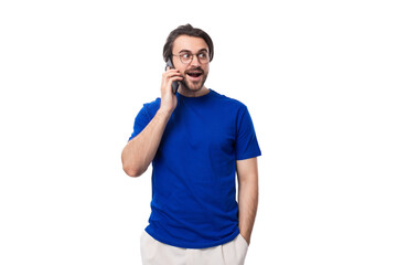 young caucasian brunette man with stylish haircut and beard speaks on the phone