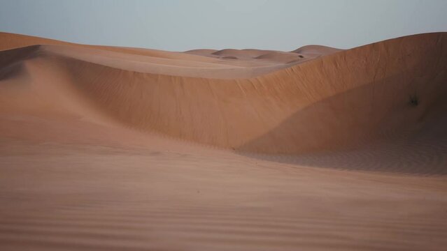 Sands dancing in the desert wind. Serene movement, natural beauty and tranquil scenes. Ideal for nature, relaxation, and atmospheric footage.