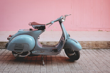 old vintage motocycle retro classic motorbike scooter style parking on the pink wall in city street - obrazy, fototapety, plakaty
