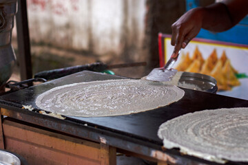 Dosa making at the road side veg restaurant or stall.