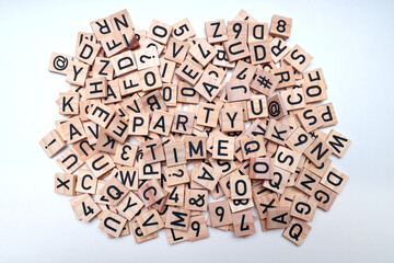 Stack of wooden letter, numbers, and punctuation mark blocks mixed together with the text 'Party Time' on top.