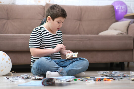 little cute boy playing lego toys at home.
