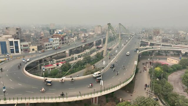 Aerial drone pan shot of traffic movement along Azadi bridge in Pakistan during morning time.
