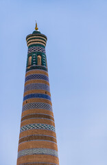 Ancient minaret Islam Khoja Minaret on a sunny summer day in the ancient city of Khiva in Khorezm