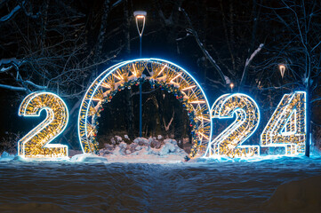 2024 New Year Numbers led light decoration. Night outdoor snowy park