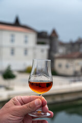 Tasting of cognac alcohol drink and view on old streets and houses in town Cognac, Grand Champagne,...