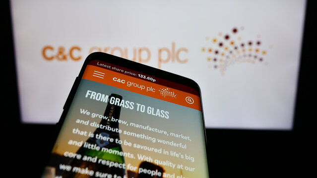 Stuttgart, Germany - 12-05-2023: Mobile phone with website of Irish alcoholic beverages company C and C Group plc (CC) in front of logo. Focus on top-left of phone display.