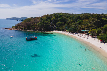 people swimming in the ocean during vacation at Koh Samet Island Thailand, aerial drone view from...