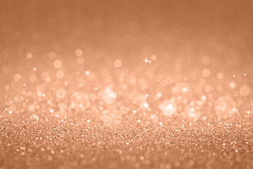 Beige abstract defocused bokeh background. Sparkling texture. Demonstrating color of 2024 year - peach.