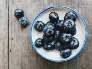 Fresh blueberry fruit on table wood background